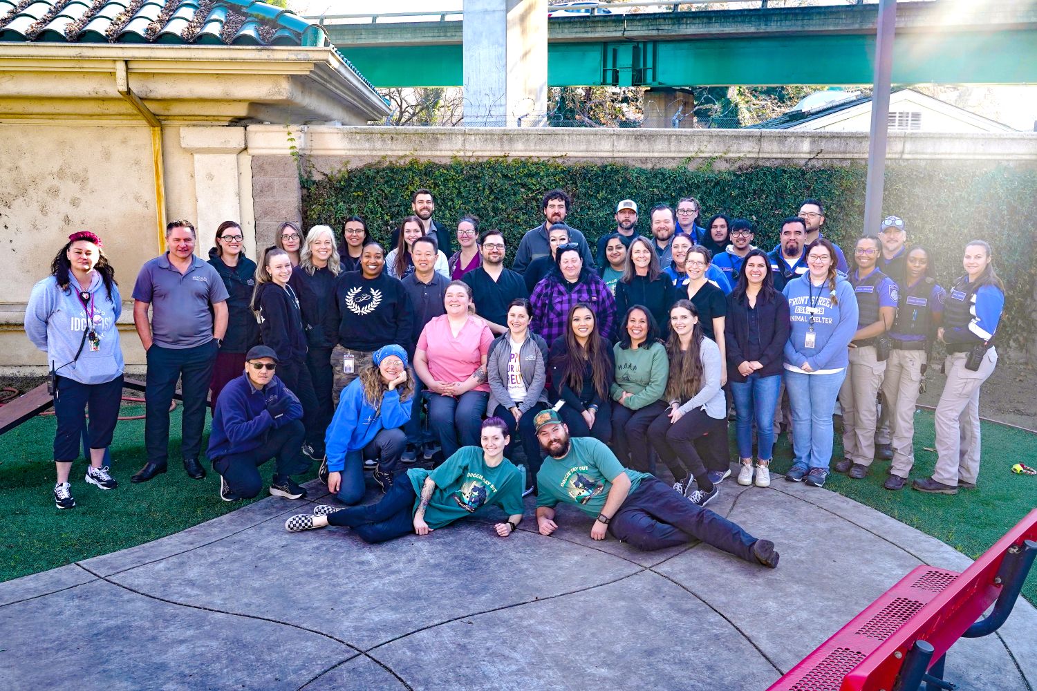 Front Street Animal Shelter staff gathered in the play yard in front of the shelter