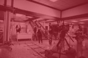 Photo of a film crew working on an indoor film set