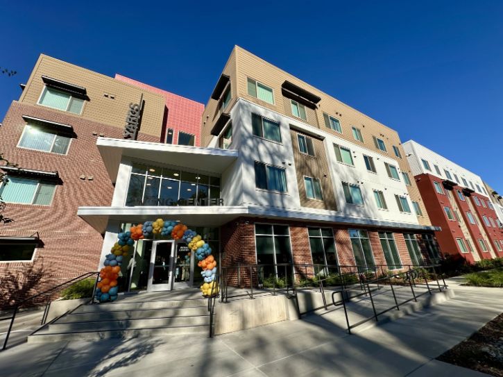 Tan and brick building, Wong Senior Center, arch of balloons, ramp