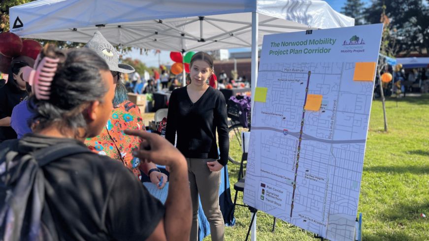 Two people looking at map of Norwood Mobility Project plan