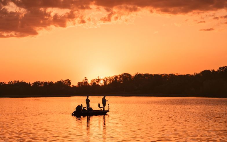 Silhouette of two people on boat
