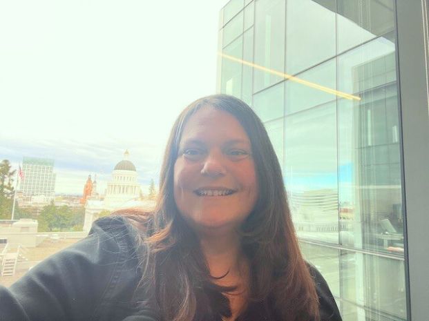 Photo of Nicole Curran with view of State Capitol in the background