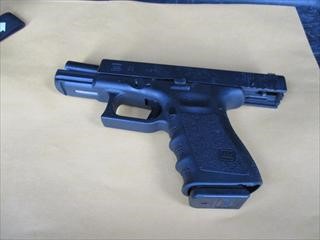 A photo of the black handgun which officers recovered in the immediate proximity of the suspect.