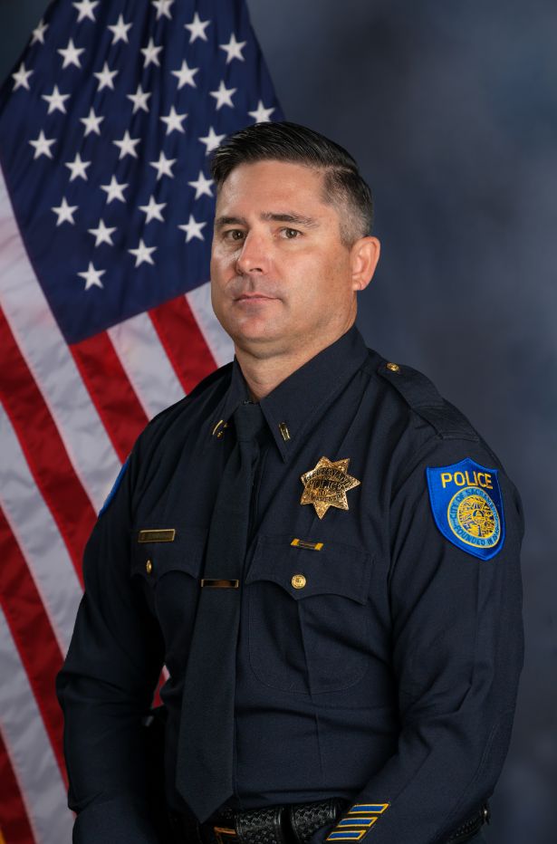 Photo of Sean Cunningham in uniform standing in front of the American flag.