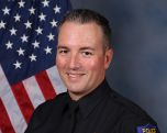 A portrait photo of the Sacramento Police Department Lieutenant Chad Coughran, in full class-A uniform